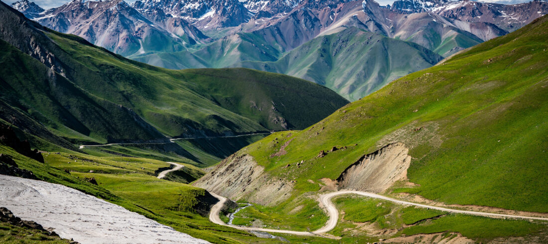 Winding footpath through green mountains