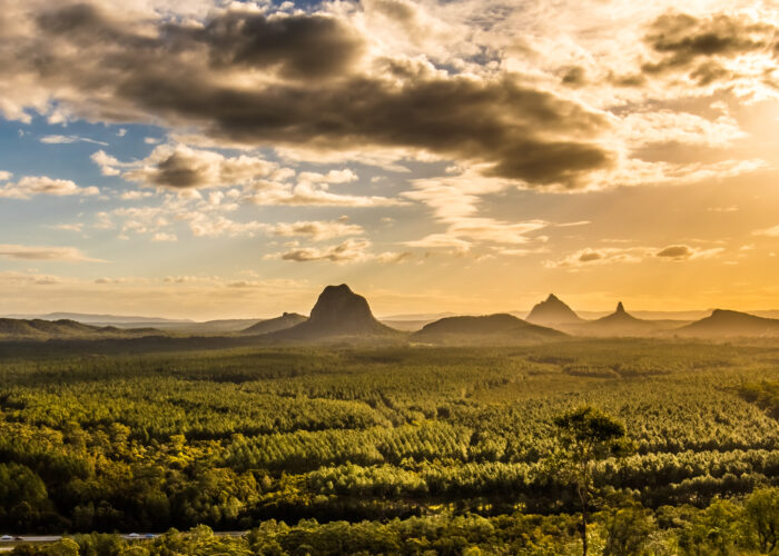 View across the valley to the mountain peaks in the distance at sunset